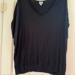 Black shirt with sequins on the arm.